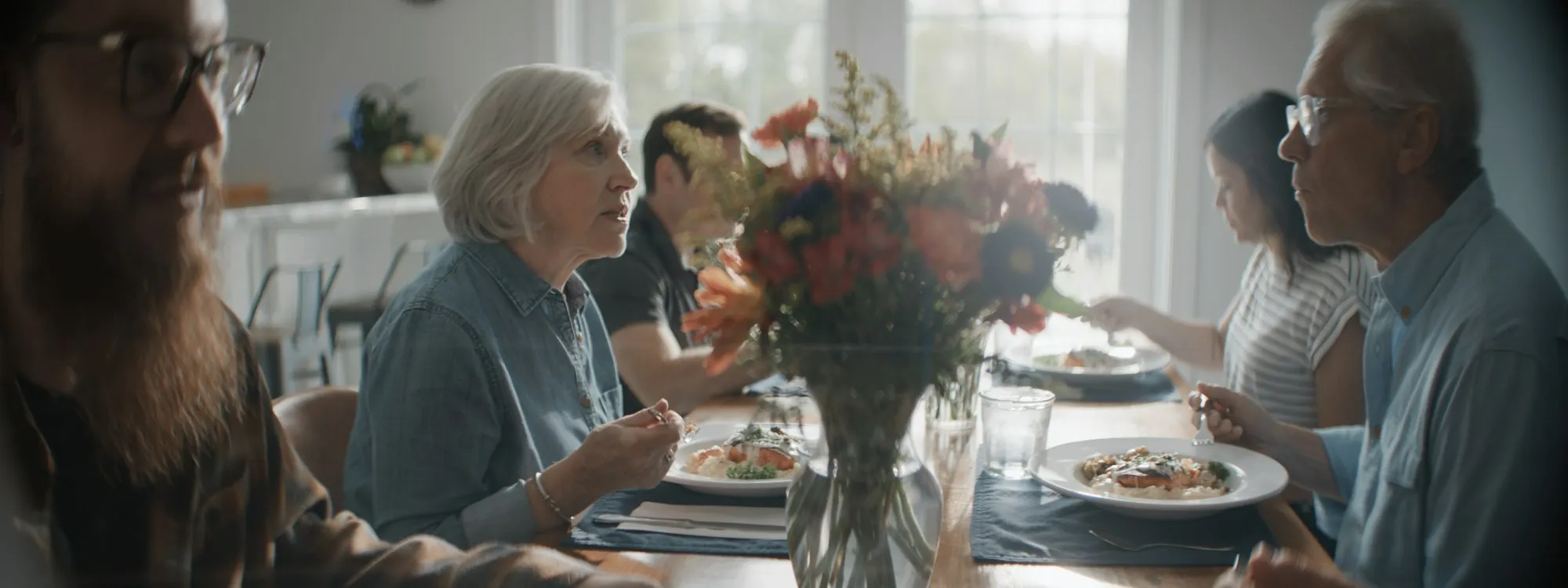 A family eating together at a long wooden table